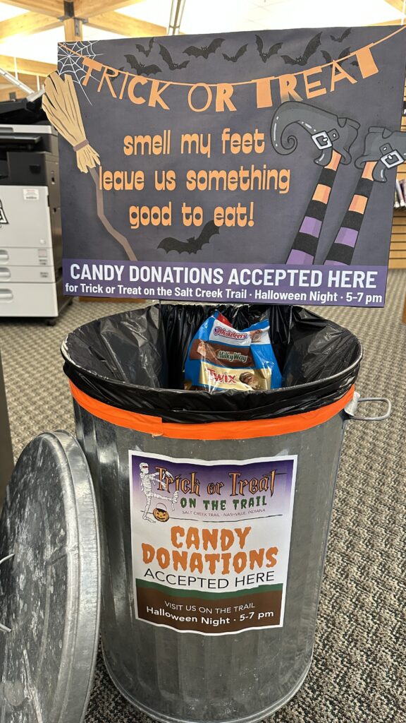 silver metal garbage pail decorated for Halloween